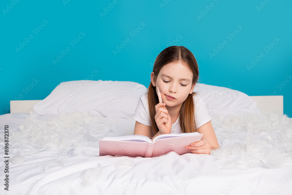 Photo of pretty lovely dreamy girl lying comfortable bed write diary isolated on blue color background Photo of pretty lovely dreamy girl lying comfortable bed write diary isolated on blue color background