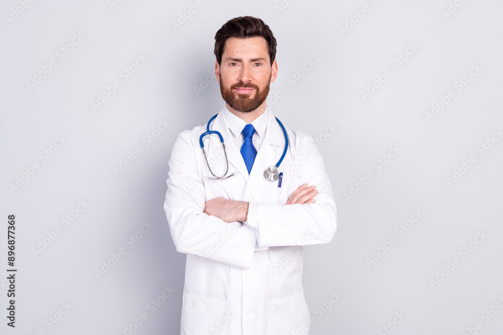 Photo of professional qualified doctor crossed arms wear white coat isolated on grey color background Photo of professional qualified doctor crossed arms wear white coat isolated on grey color background