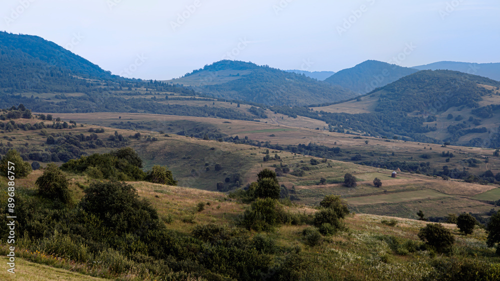 Mountain farmland landscape with haystacks Mountain farmland landscape with haystacks