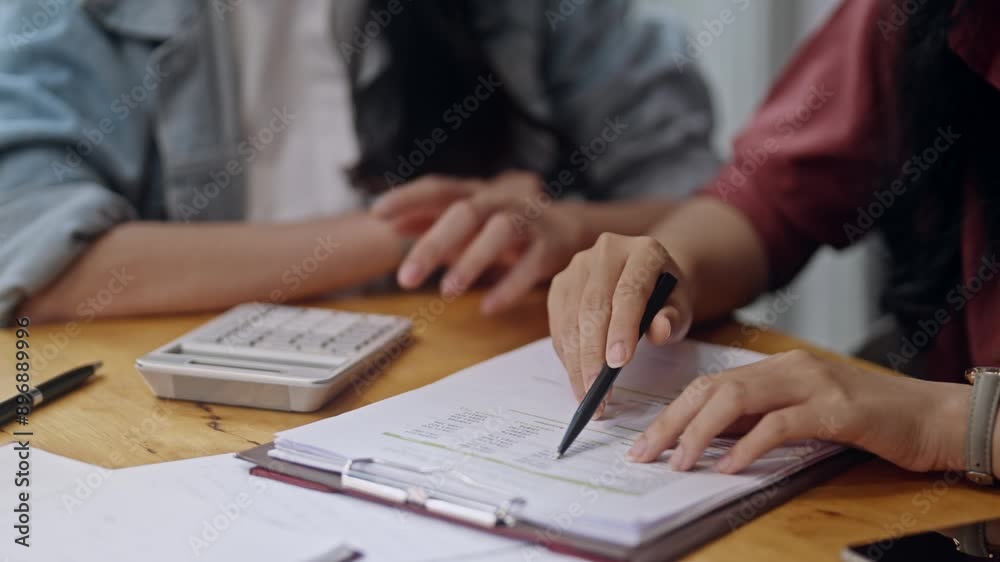 Two Asian university students tutoring together before examination Two Asian university students tutoring together before examination