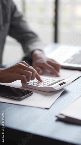 Asian male audit accountant calculating invoice and tax, Financial concept