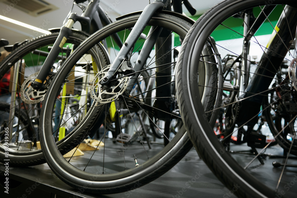 Mountain bike on rack showcase in shop closeup on bicycle wheels Mountain bike on rack showcase in shop closeup on bicycle wheels