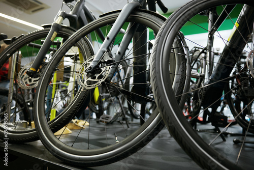 Mountain bike on rack showcase in shop closeup on bicycle wheels