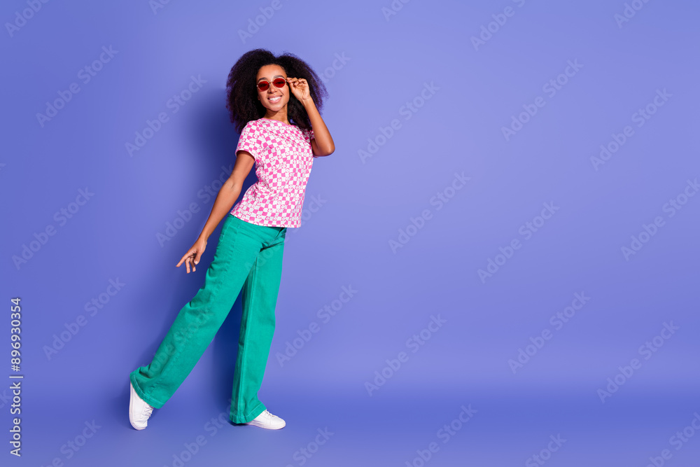 Photo of cheerful positive glad woman wear trendy clothes empty space isolated on purple color background Photo of cheerful positive glad woman wear trendy clothes empty space isolated on purple color background