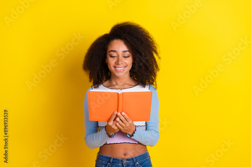 Photo portrait of lovely young lady read book dressed stylish blue garment isolated on yellow color background