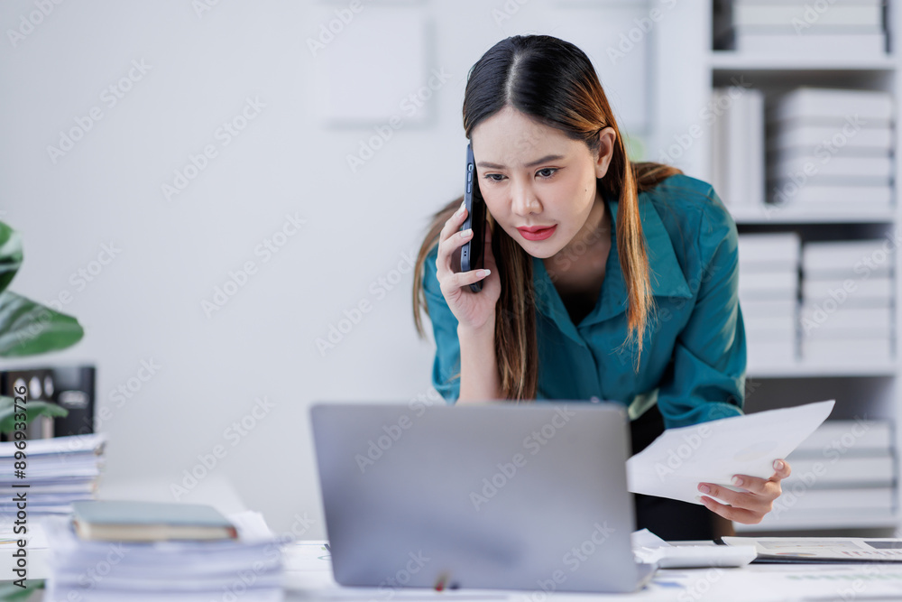 Cheerful business Asian woman employee making telephone call share good news about project work in office workplace, business financing accounting banking concept. Cheerful business Asian woman employee making telephone call share good news about project work in office workplace, business financing accounting banking concept.