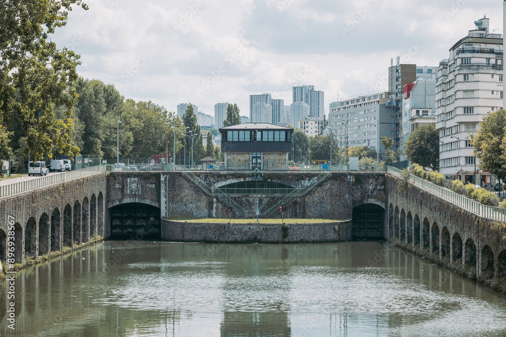 Flanders bridge lock on the river in Paris, viewed from the norh. Visible high rise buildings in the rear. Famous river locks in Paris