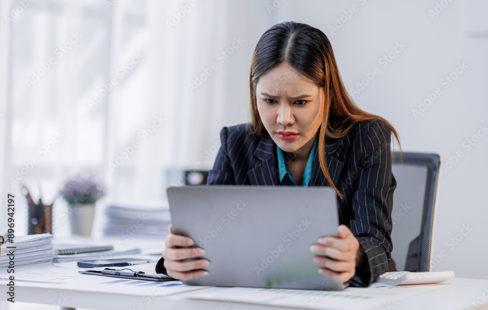 Portrait of tired business asian woman sitting at a work. documents tax laptop computer in office. Sad, unhappy, Worried, Depression, or overworked, failure employee life stress concept Portrait of tired business asian woman sitting at a work. documents tax laptop computer in office. Sad, unhappy, Worried, Depression, or overworked, failure employee life stress concept