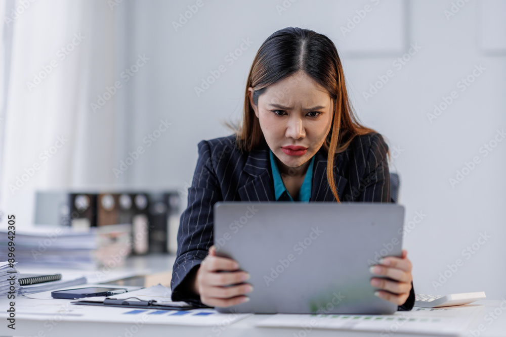 Portrait of tired business asian woman sitting at a work. documents tax laptop computer in office. Sad, unhappy, Worried, Depression, or overworked, failure employee life stress concept Portrait of tired business asian woman sitting at a work. documents tax laptop computer in office. Sad, unhappy, Worried, Depression, or overworked, failure employee life stress concept