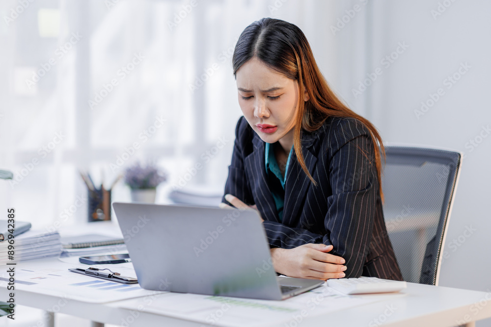 Portrait of tired business asian woman sitting at a work. documents tax laptop computer in office. Sad, unhappy, Worried, Depression, or overworked, failure employee life stress concept Portrait of tired business asian woman sitting at a work. documents tax laptop computer in office. Sad, unhappy, Worried, Depression, or overworked, failure employee life stress concept