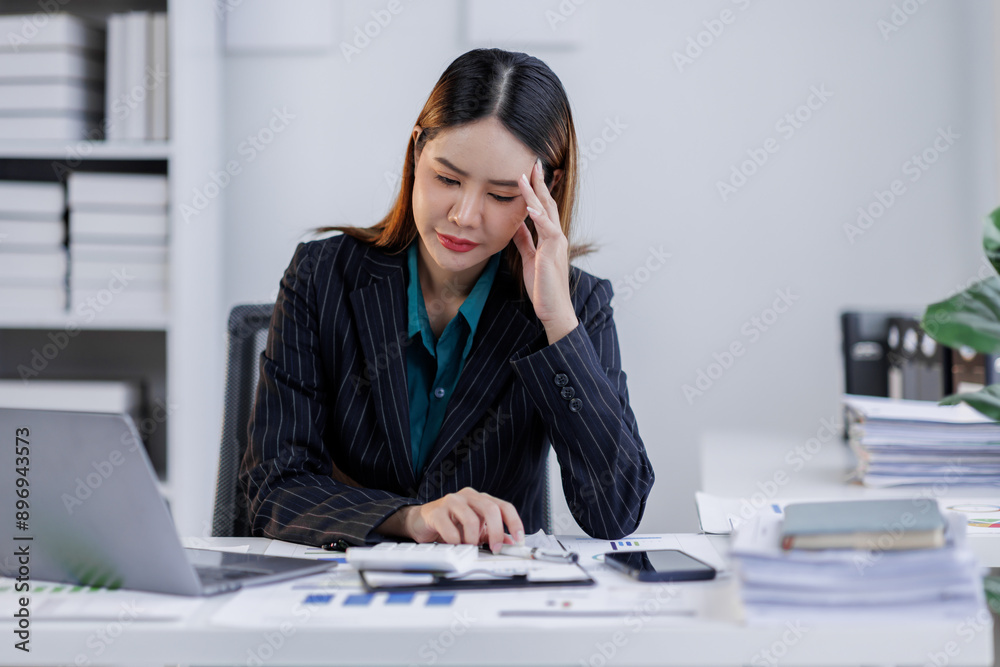Portrait of tired business asian woman sitting at a work. documents tax laptop computer in office. Sad, unhappy, Worried, Depression, or overworked, failure employee life stress concept Portrait of tired business asian woman sitting at a work. documents tax laptop computer in office. Sad, unhappy, Worried, Depression, or overworked, failure employee life stress concept