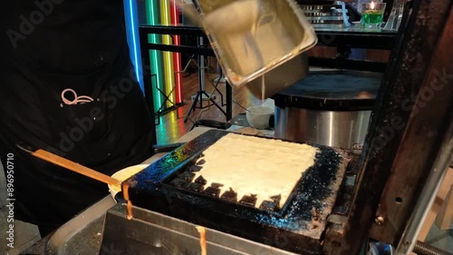 Person making waffle with waffle machines.