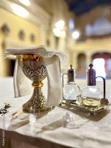 Chalice and ampoules prepared for a mass on the altar in a church.
