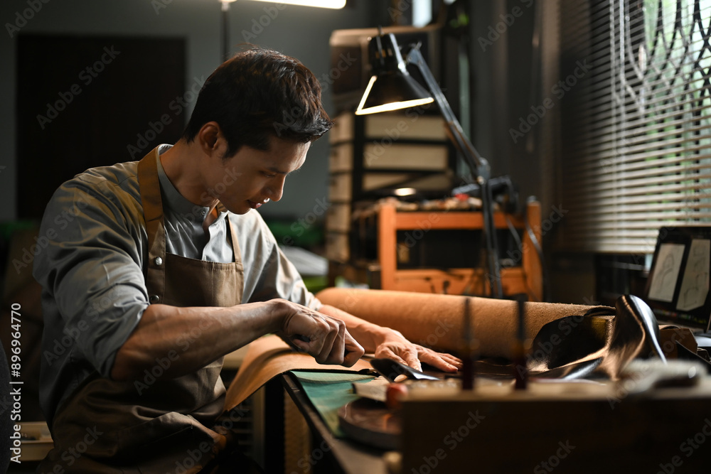 Dedicated craftsman focusing intently on his task at workshop Dedicated craftsman focusing intently on his task at workshop