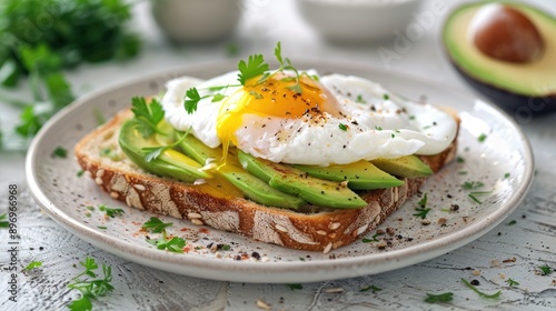 Poached egg on avocado toast. This image shows a healthy and delicious breakfast option perfect for food blogs or recipes.