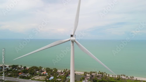 Sustainable Renewable Green Clean Energy, Kinetic Wind Energy Turbine by the Coast of the Tropical Sea photo