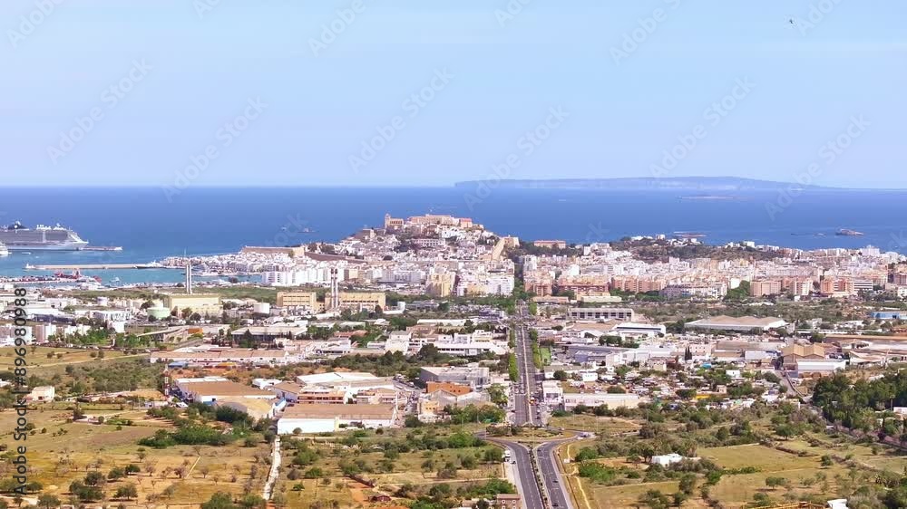 Drone shot - 4K - Aerial view of Ibiza (Spain) city of Balearic Islands with the beach and buildings in a sunny day Drone shot - 4K - Aerial view of Ibiza (Spain) city of Balearic Islands with the beach and buildings in a sunny day