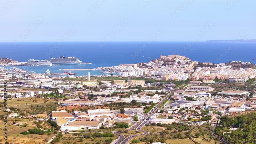 Drone shot - 4K - Aerial view of Ibiza (Spain) city of Balearic Islands with the beach and buildings in a sunny day Drone shot - 4K - Aerial view of Ibiza (Spain) city of Balearic Islands with the beach and buildings in a sunny day