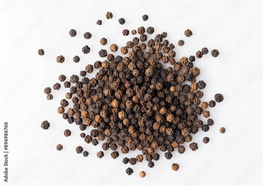 Black pepper scattered on a white background with professional color grading. Black pepper scattered on a white background with professional color grading.