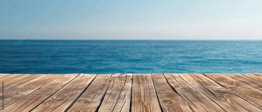 Obraz premium A wood table with a functional style overlooking a serene ocean view, emphasizing practicality and coastal beauty, banner, with copy space