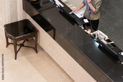 Asian receptionist working at counter