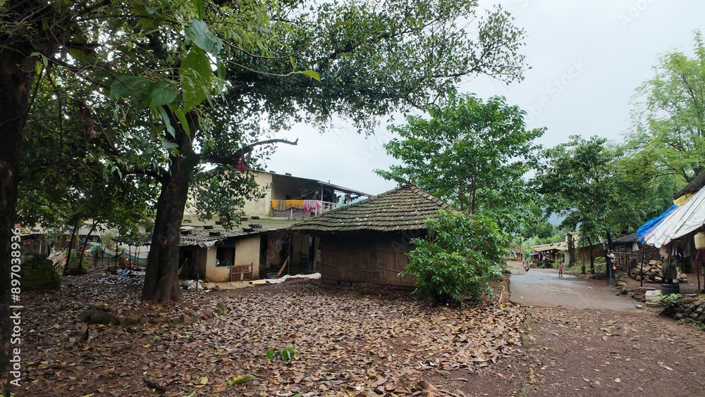 A rural village in Maharashtra with houses under a cloudy sky during the monsoon season, showcasing the serene landscape.
A rural village in Maharashtra with houses under a cloudy sky during the monsoon season, showcasing the serene landscape.