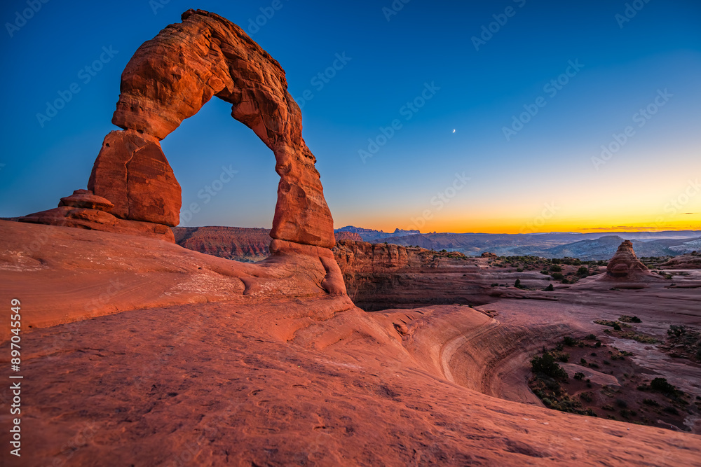 Delicate Arch - The most famous landmark of the Arches National Park in Utah after sunset in blue hour twilight.