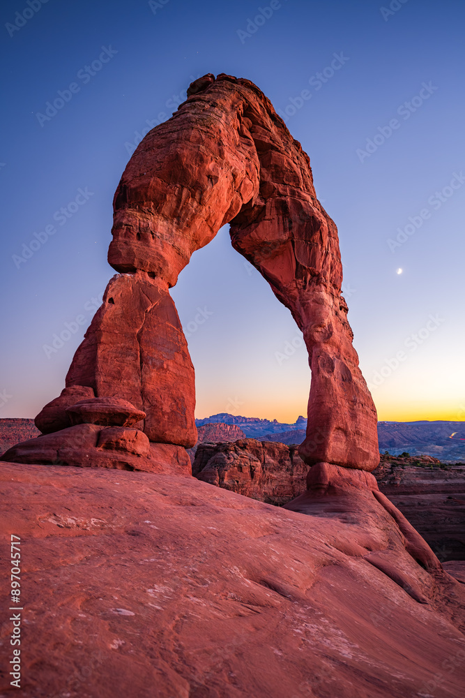 Delicate Arch - The most famous landmark of the Arches National Park in Utah after sunset in blue hour twilight.