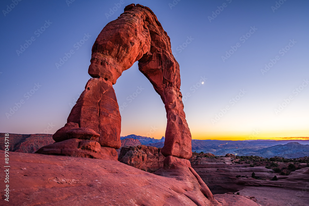 Delicate Arch - The most famous landmark of the Arches National Park in Utah after sunset in blue hour twilight.