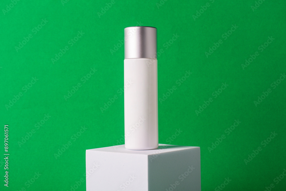 White sunscreen bottle on green background. Sunscreen concept. Skin care concept. Copy space. White sunscreen bottle on green background. Sunscreen concept. Skin care concept. Copy space.