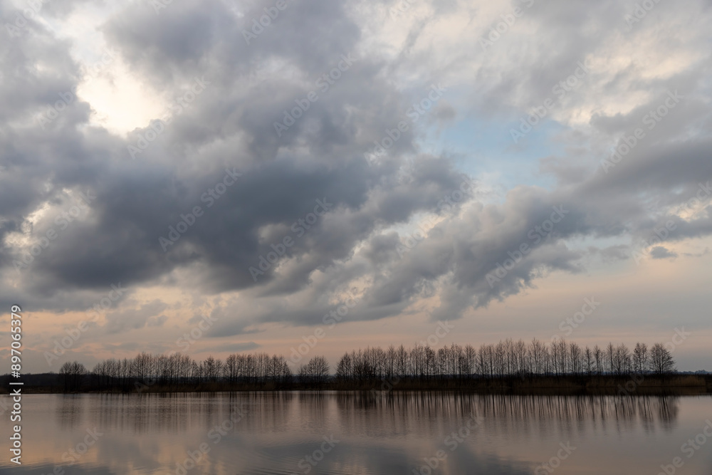 a beautiful reflection of the sky and clouds in the lake at sunset a beautiful reflection of the sky and clouds in the lake at sunset