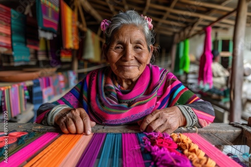 An elderly woman with gray hair and a gentle smile weaves bright textiles with skilled hands in a rustic setting, surrounded by colorful threads and woven fabrics, depicting tradition.