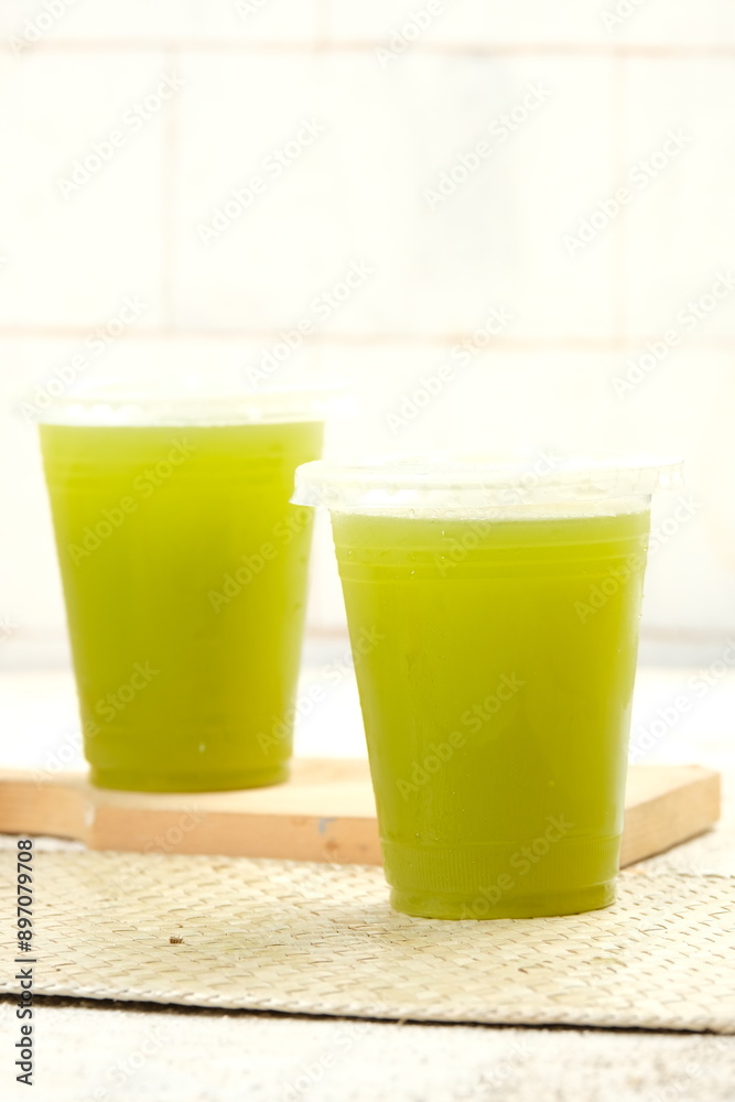 Refreshing sugarcane juice in clear plastic cups with frothy tops, perfect for summer themes, healthy drink promotions, and tropical beverage advertisements. Ideal for cafes, menus, and social media. Refreshing sugarcane juice in clear plastic cups with frothy tops, perfect for summer themes, healthy drink promotions, and tropical beverage advertisements. Ideal for cafes, menus, and social media.
