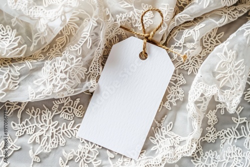 Empty white gift tag mockup. Paper label on embroidered clothes photo