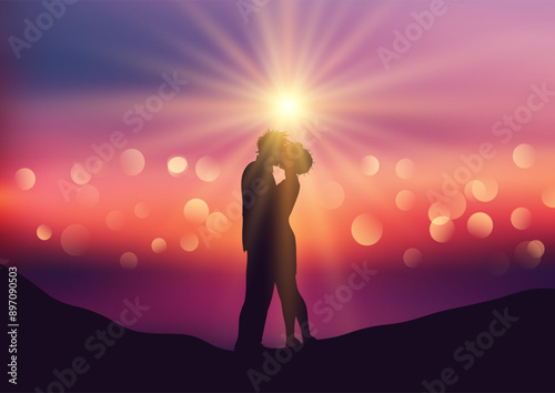 Silhouette of kissing couple on a defocussed sunset background