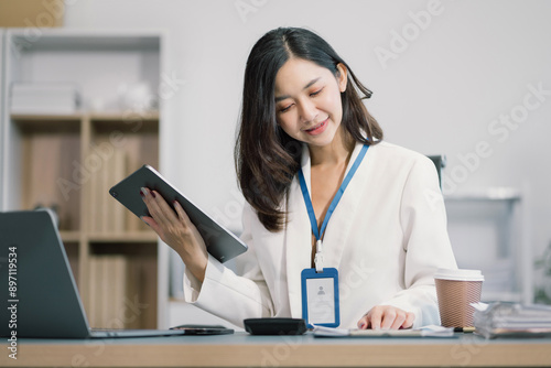 Businessman using laptop computer in office. Happy woman, entrepreneur, small business owner working online.