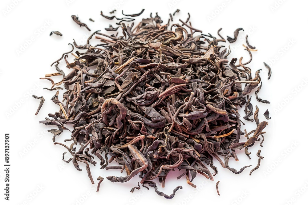 Fototapeta premium A pile of dried tea leaves on a white surface, great for photography or illustration projects