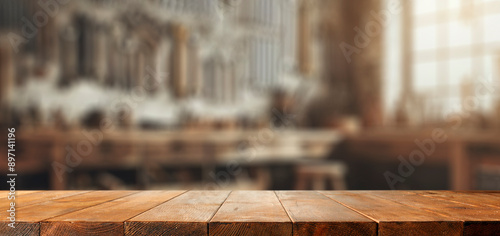 Fototapeta Naklejka Na Ścianę i Meble -  Empty wooden work table with space for tools and products. Blurred background of craft workshop and wall with tools.