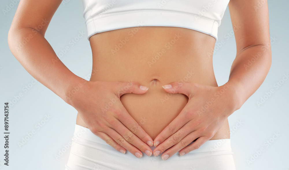 Hands, woman and stomach for health in studio with gut wellness, weight loss and body goal from diet routine. Female person, abdomen and underwear for transformation, digestion and white background