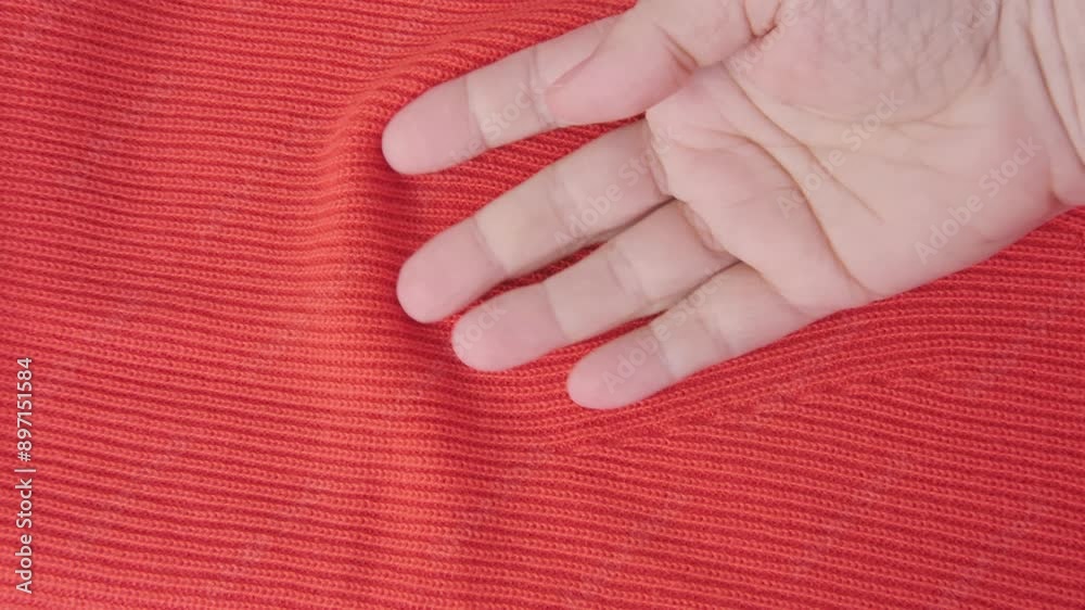 female Hand touching knitted wool cloth or warm fluffy sweater, Handcraft knitting woolen fabric surface, tactile properties, fabric testing