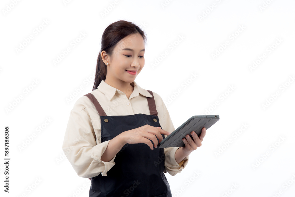 Portrait happy young asian barista woman in apron smiling while using digital tablet isolated white background, waitress or entrepreneur looking tablet, small business or startup, waiter of cafe. Portrait happy young asian barista woman in apron smiling while using digital tablet isolated white background, waitress or entrepreneur looking tablet, small business or startup, waiter of cafe.