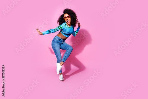 Full size photo of lovely young lady dancing have fun summer party dressed stylish blue garment isolated on pink color background