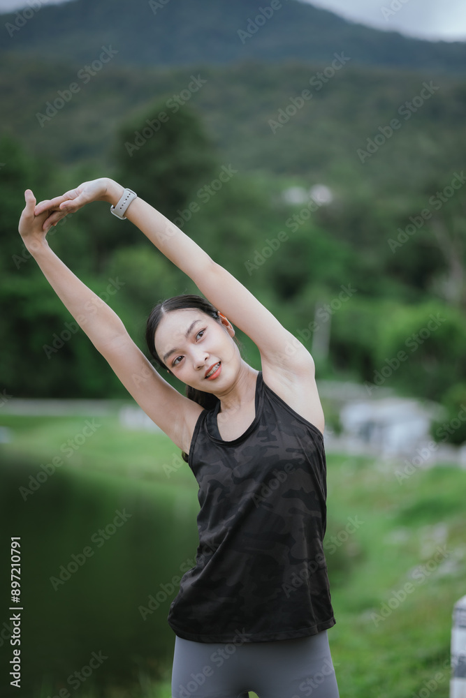 A young, beautiful Asian woman runs happily in a city park on a summer morning. Embracing an active lifestyle, she enjoys outdoor exercise, showcasing fitness, health, vitality, and a joyful, healthy A young, beautiful Asian woman runs happily in a city park on a summer morning. Embracing an active lifestyle, she enjoys outdoor exercise, showcasing fitness, health, vitality, and a joyful, healthy