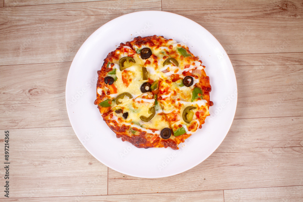 Delicious pizza served on white plate isolated on wooden background