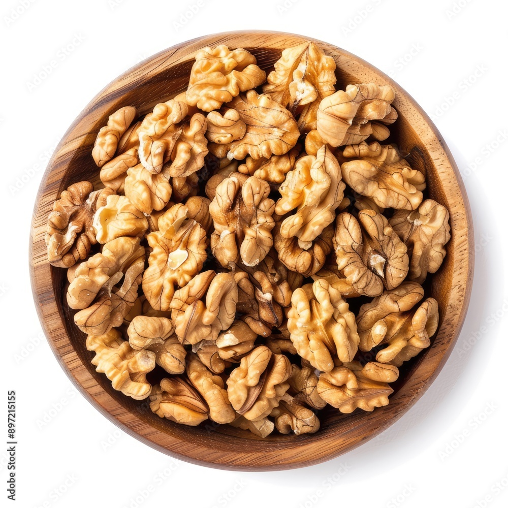 A wooden bowl filled with walnut halves A wooden bowl filled with walnut halves