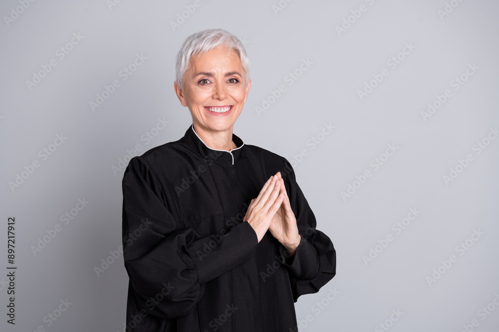 Photo of smiling judge woman put fingers together look wear black robe isolated grey color background Photo of smiling judge woman put fingers together look wear black robe isolated grey color background