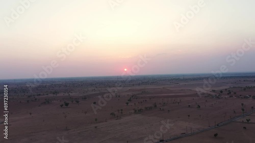 Beautiful sunset time view of  a small town of phalodi jodhpur rajasthan, beautiful sunset in dessert of rajasthan and vehicle passing on a highway road of dessert.. photo