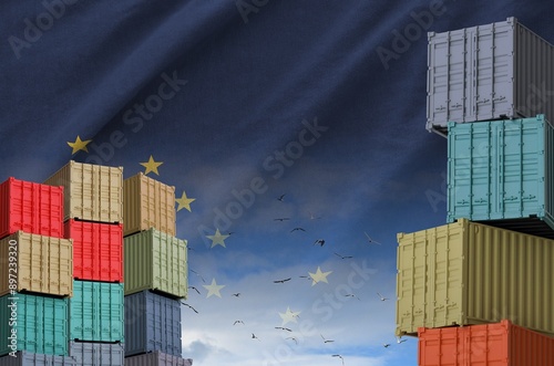 Alaska US state flag and big stack of shipping cargo containers in docks with sky background close up photo