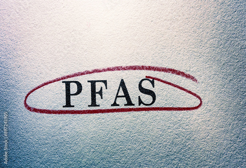 PFAS -- Forever Chemicals -- text circled on textured background