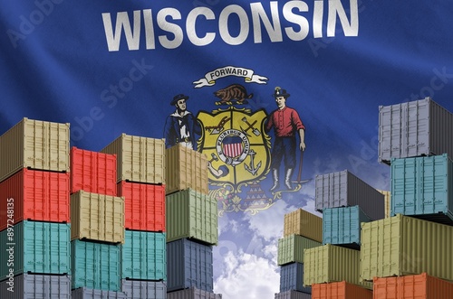 Wisconsin US state flag and big stack of shipping cargo containers in docks with sky background close up photo